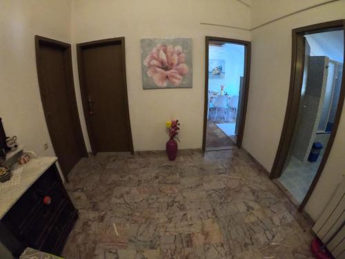 a room with a vase of flowers on the wall at Apartments Malina in Tučepi