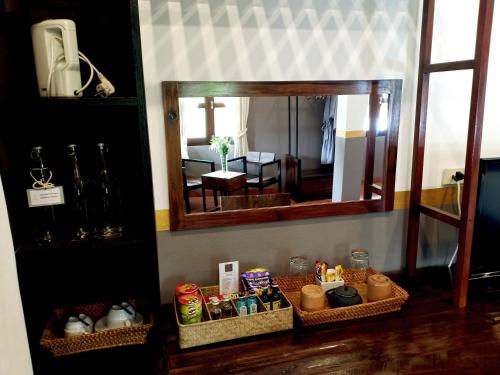 a mirror in a room with baskets of food at Sanctuary Hotel Luang Prabang in Luang Prabang