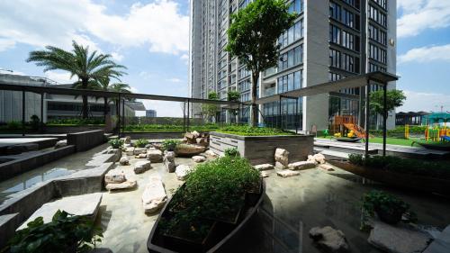 a courtyard in a building with rocks and plants at Shendo Vinhomes Metropolis in Hanoi