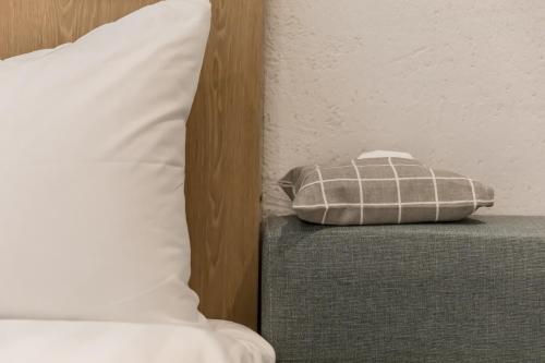 a pillow sitting on a couch next to a bed at Tiin Tinn Inn - Tiehua Xiutai in Taitung City