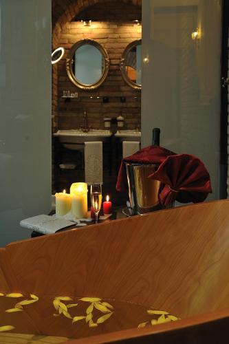 a table with two candles and a counter top at Hotel Bonconte in Urbino