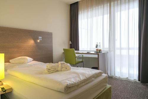 a hotel room with two beds and a desk at Gästehaus Fernblick in Bad Wimpfen