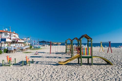 a group of playground equipment on a beach at Comfortable apartment near the central beach in Nea Skioni