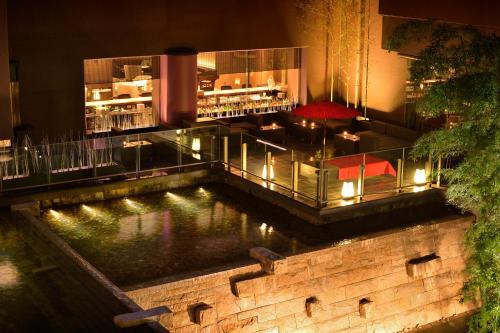 a restaurant with a pond in front of a bar at Kyoto Tokyu Hotel in Kyoto