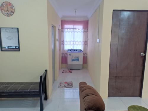 a room with a hallway with a bed and a door at Homestay pekan ranau in Ranau