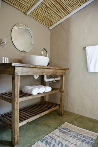 a bathroom with a sink and a mirror at African Game Lodge in Montagu