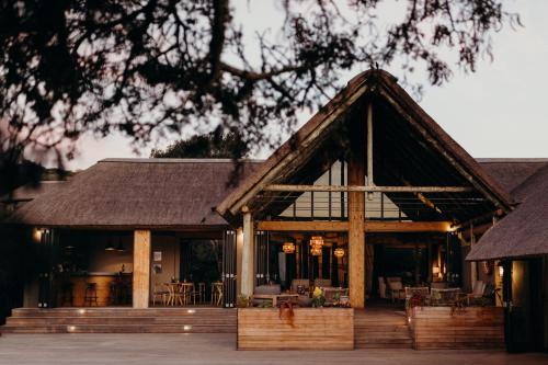 a house with a thatched roof at Bukela Game Lodge - Amakhala Game Reserve in Amakhala Game Reserve