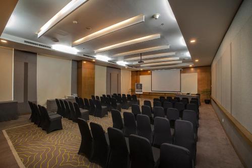 a conference room with chairs and a whiteboard in it at eL Hotel Jakarta in Jakarta