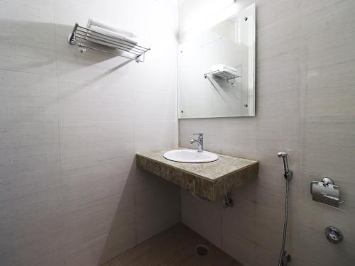a bathroom with a sink and a mirror at Hotel Green Valley in Katra