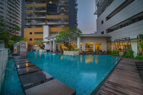 a large swimming pool in the middle of a building at eL Hotel Jakarta in Jakarta