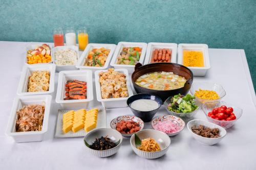 a table topped with containers of different types of food at Hotel Wing International Select Kumamoto in Kumamoto