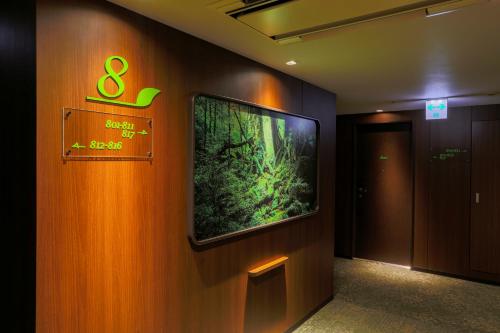 a wall with a large tv on a wall at Hotel Wing International Select Kumamoto in Kumamoto