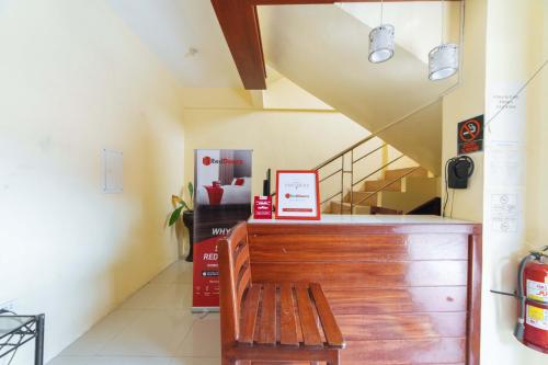 a wooden bench in a room with a staircase at RedDoorz @ D Maagma Street in Kalibo