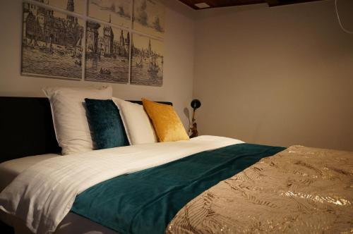 a bed in a bedroom with posters on the wall at Charming Suites Jan Zonder Vrees in Antwerp