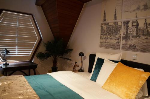 a bedroom with a large bed and a window at Charming Suites Jan Zonder Vrees in Antwerp