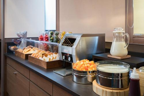 a kitchen with a counter with food and a blender at Vessel Hotel Kurashiki in Kurashiki