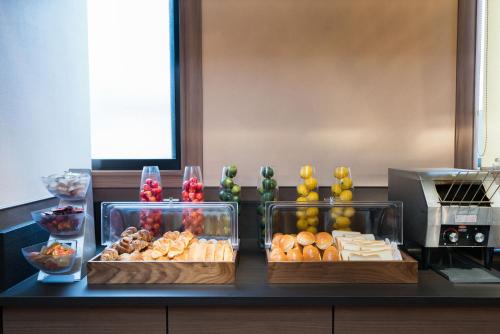 a buffet with different types of food on a counter at Vessel Hotel Kurashiki in Kurashiki