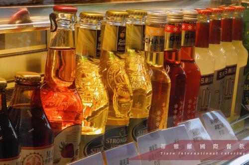 a display of different types of bottles of alcohol at Darlon Hotel in Hsinchu City