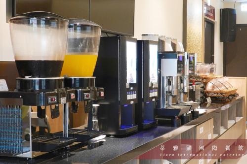 a row of coffee machines sitting on a counter at Darlon Hotel in Hsinchu City