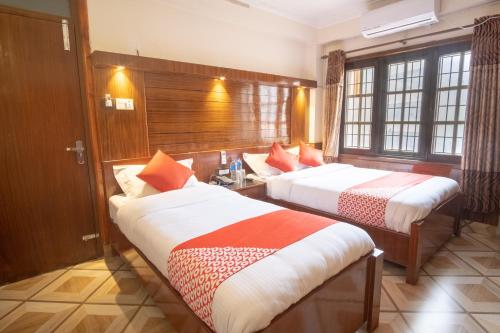Кровать или кровати в номере OYO 304 Hotel Manama