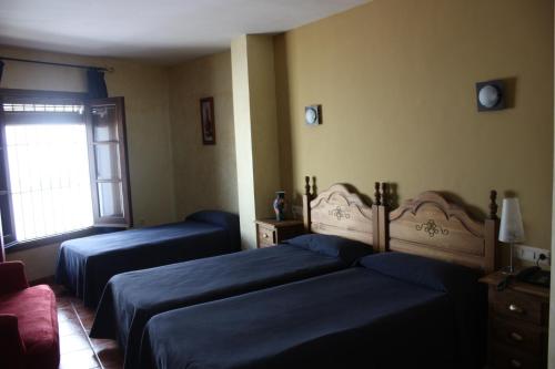 Ένα ή περισσότερα κρεβάτια σε δωμάτιο στο Hotel Don Pero