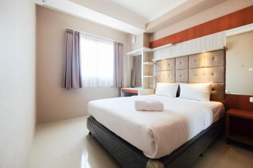 Ένα ή περισσότερα κρεβάτια σε δωμάτιο στο Great Location 1BR Signature Park Grande Apartment By Travelio