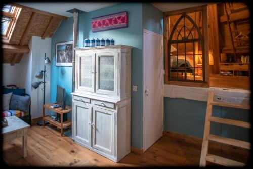 a room with a white cabinet and a window at Grand studio duplex proche de la mer in Fécamp