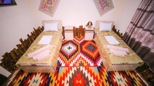 Ένα ή περισσότερα κρεβάτια σε δωμάτιο στο Khiva Muhammadali