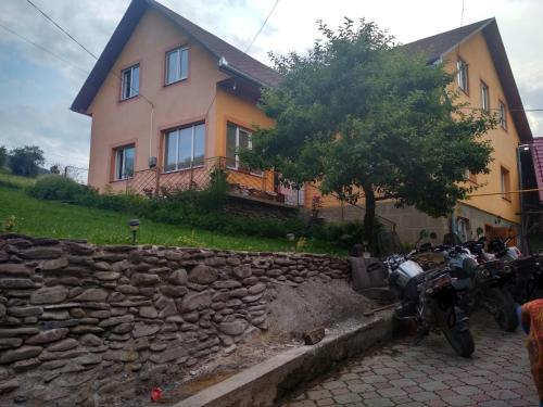 a group of motorcycles parked in front of a house at Садиба" У Василя" in Volovets