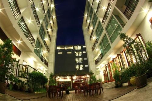 a large building with tables and chairs in it at Sabaidee@Lao Hotel Vientiane in Vientiane
