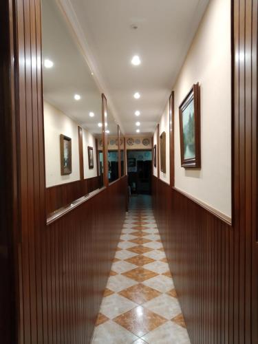 a hallway in a building with a tiled floor at HOSTAL RESIDENCIA PRESIDENTE in Ribadeo