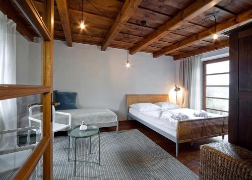 a bedroom with two beds and a table in a room at Kurdějov 52 in Kurdějov