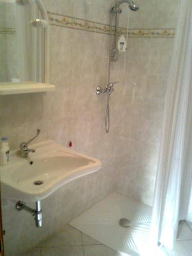 a bathroom with a shower and a sink at Villa Benice in Morino