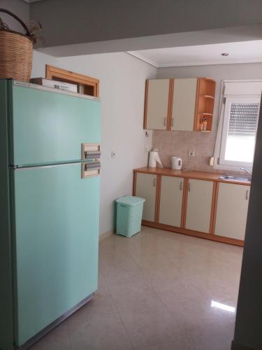 a kitchen with a large refrigerator in a room at Studio Mytilene View in Mytilini