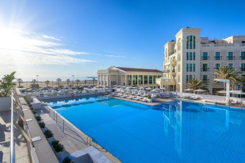 a large swimming pool in front of a hotel at Las Arenas Balneario Resort in Valencia