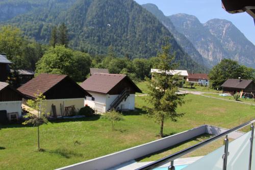 a view of a village with mountains in the background at Hideaway Obertraun in Obertraun
