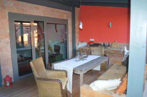 a dining room with a white table and chairs at Bootshaus in Eisenstadt