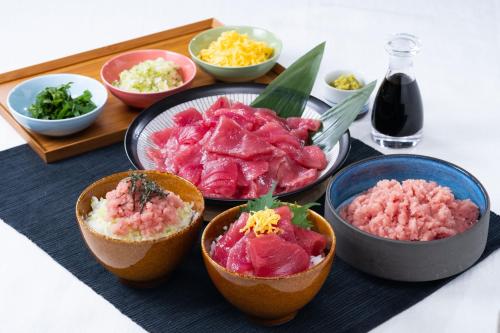 a table topped with bowls of different types of food at Vessel Inn Ueno Iriya Ekimae in Tokyo