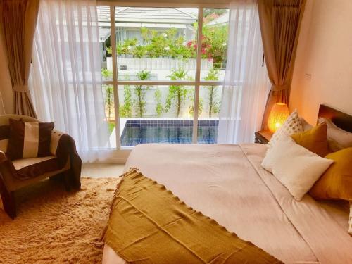 a bedroom with a large bed and a window at 2 Bedroom Luxury Pool Villa Orchid short walk to Beach SDV002-By Samui Dream Villas in Mae Nam
