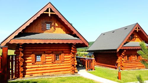 a log cabin with a cross on the roof at Ubytovanie Koliba Pacho - Zrub Evka in Prievidza