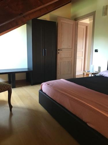 a bedroom with a bed and a closet and a window at La Morona in Rocchetta Tanaro