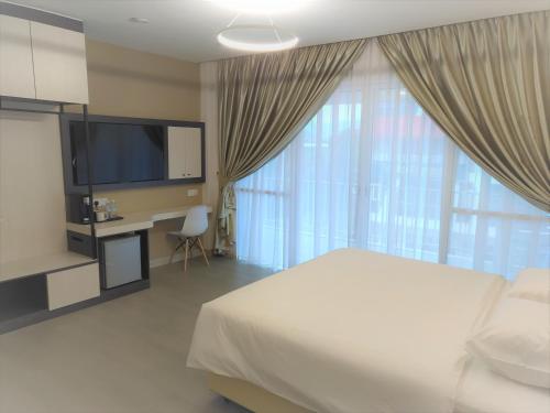 Voodi või voodid majutusasutuse Legacy Hotel Ipoh toas