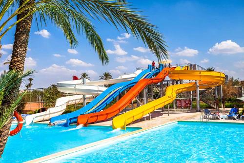 a water slide in a resort with a pool at Appart Clim Wifi 700m de la Plage in Saïdia