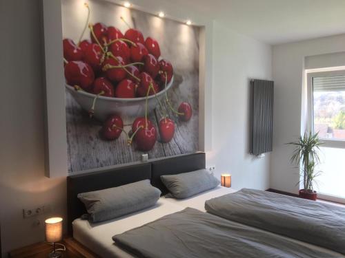 a bedroom with a painting of a bowl of cherries at Gasthof Kirschtraum in Sontra