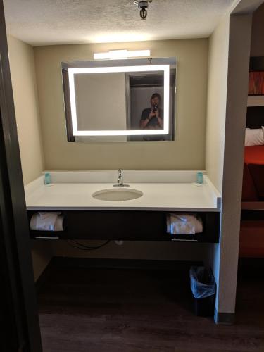a person taking a picture of a bathroom sink at Riverside Tower in Pigeon Forge