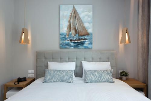 a bedroom with a bed with a sail boat on it at Melina Bay Boutique Hotel in Kassiopi