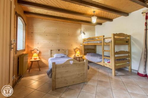 a room with two bunk beds in a house at Chalet la griotte in Abondance