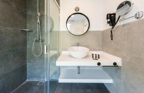 a bathroom with a sink and a shower at Plaza de España Skyline in Madrid