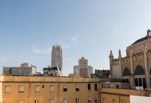 a city skyline with tall buildings in the background at Plaza de España Skyline in Madrid