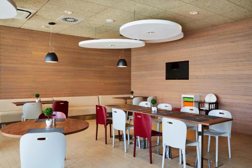 a restaurant with wooden walls and tables and chairs at Campanile Bydgoszcz in Bydgoszcz